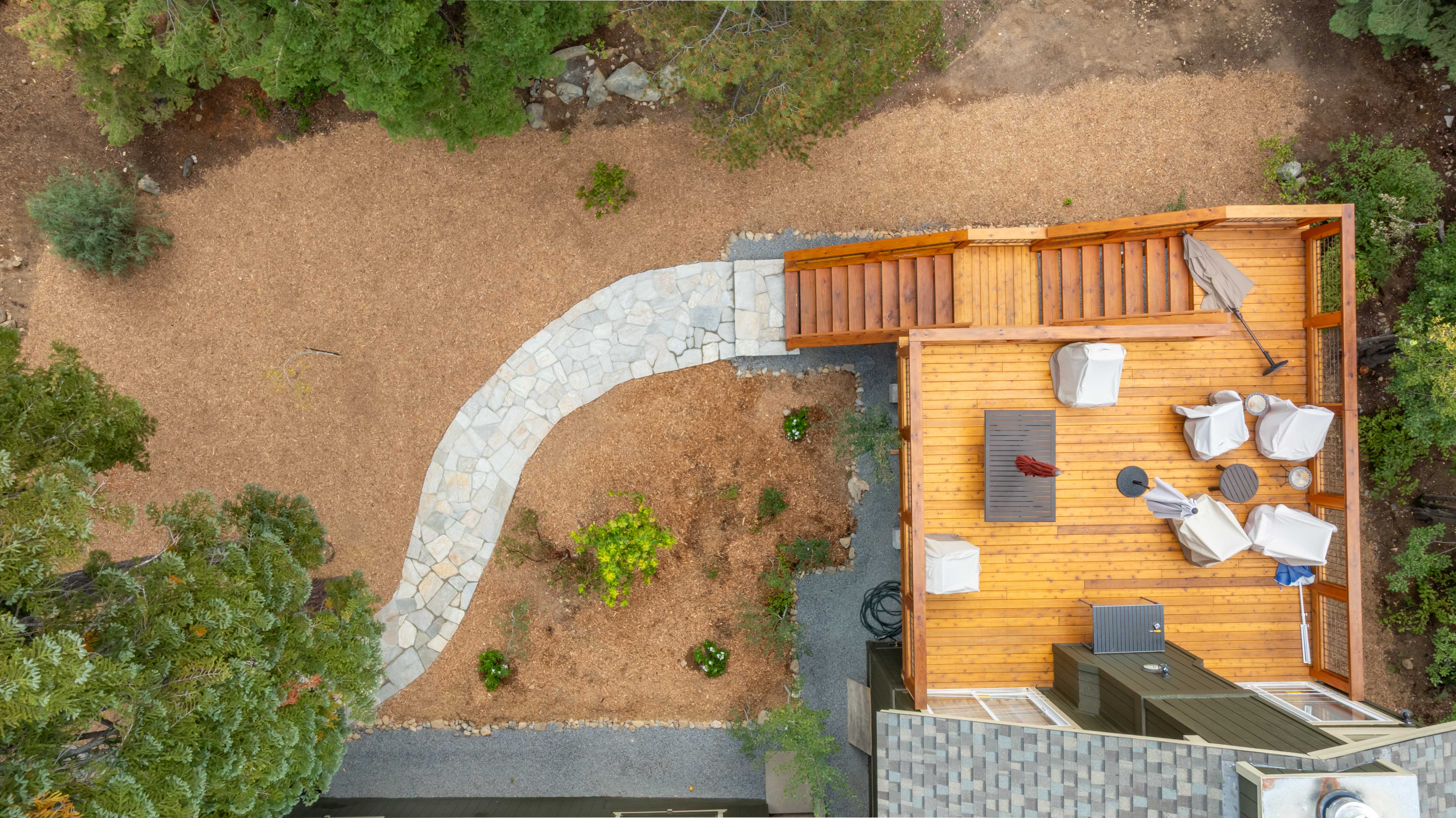 Forest landscape with stone pathway and deck in Incline Village, Lake Tahoe